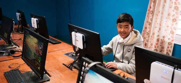 a student in front of the computer screen sitting in a classroom