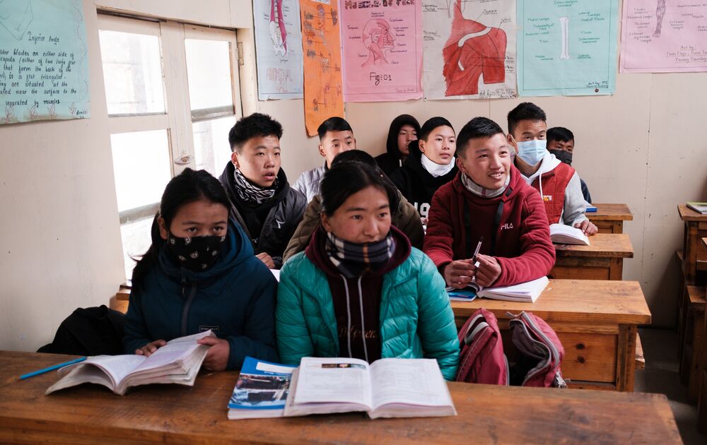 A group of students attentively seated at desks in a classroom